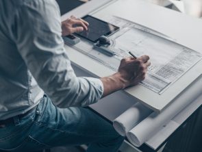 Young architect with a tablet and tools in the workplace